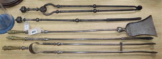 A set of three Regency steel fire implements with stylised quiver handles and two other steel fire implements